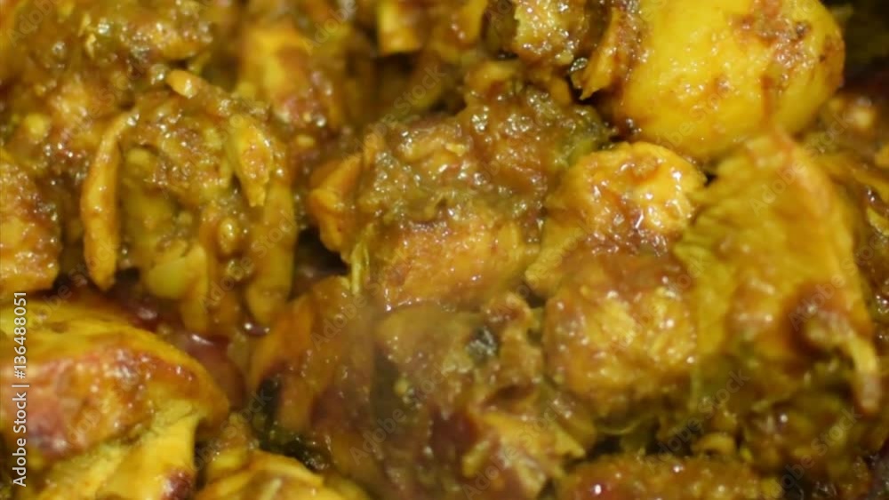 Preparation of smoking hot chicken curry, one of the spicy delicacies of Indian foods. India is famous for such colorful foods for long time. Preparation of smoking hot chicken curry, one of the spicy delicacies of Indian foods. India is famous for such colorful foods for long time.