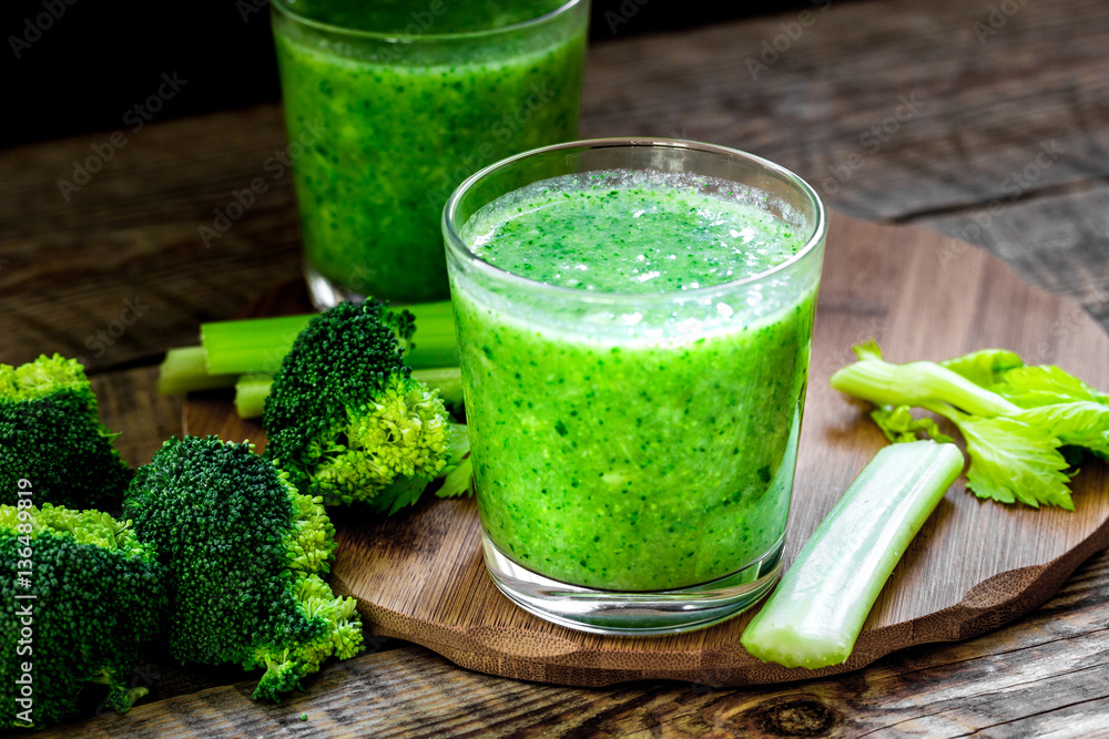 Green vegetable smoothie in glass at wooden background Green vegetable smoothie in glass at wooden background