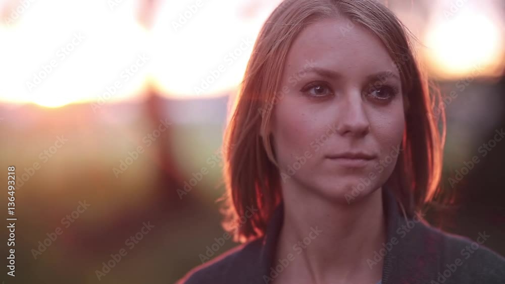 Portrait of beautiful blonde pensive woman outdoor in the summer, looking into the distance on sunset, close-up Portrait of beautiful blonde pensive woman outdoor in the summer, looking into the distance on sunset, close-up