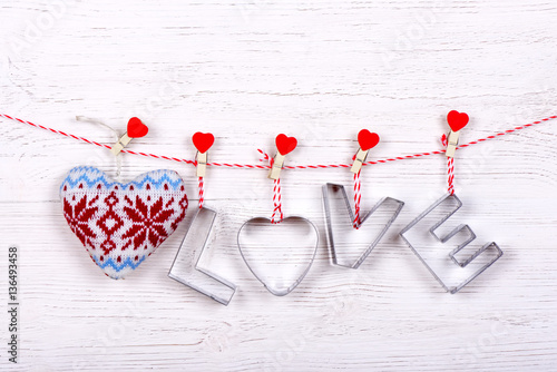 Silver text Love and heart for Happy Valentine's Day celebration on a white wooden background
