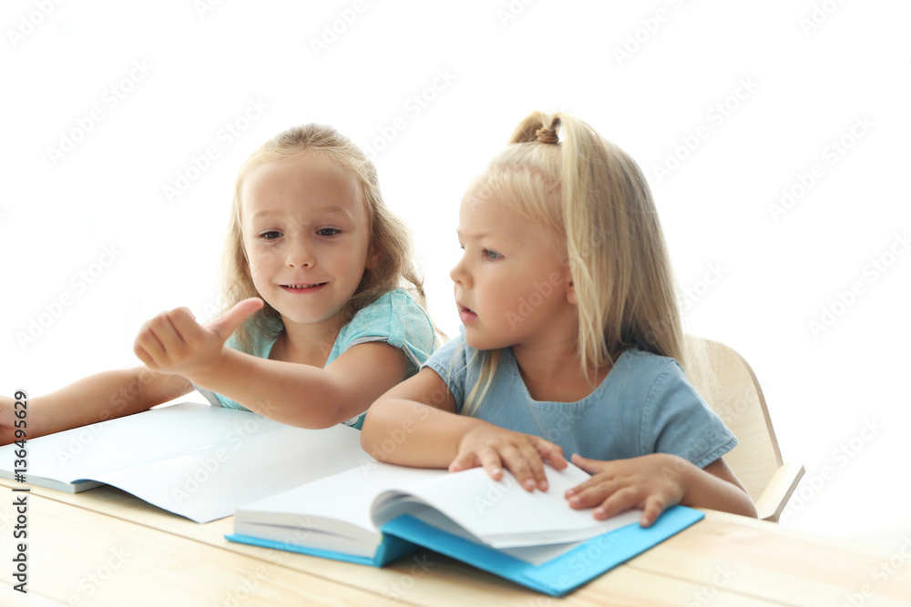 Sisters doing homework together at table Sisters doing homework together at table