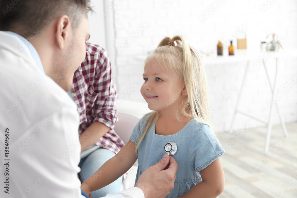 Male pediatrician doctor examining small girl Male pediatrician doctor examining small girl