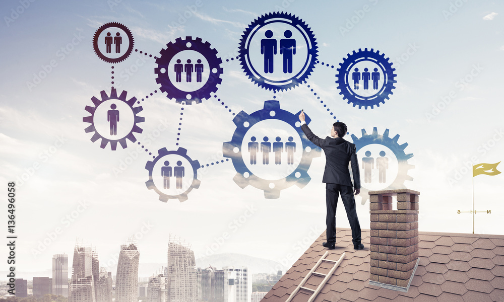 Businessman on house roof presenting teamwork and connection con Businessman on house roof presenting teamwork and connection con