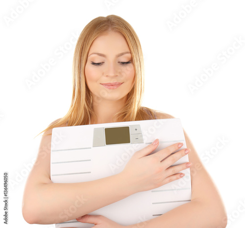 Young woman with scales on white background