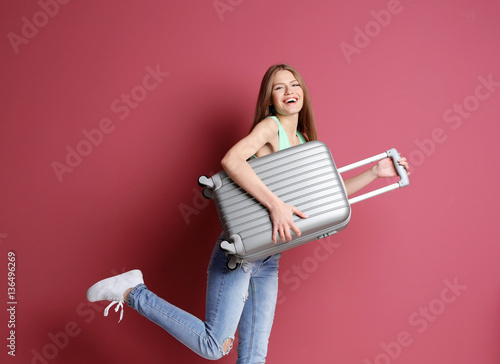 Woman traveler with suitcas...