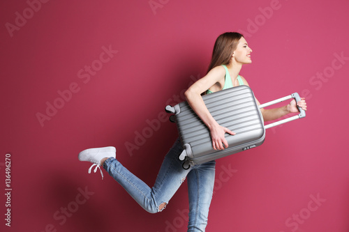 Woman traveler with suitcas...
