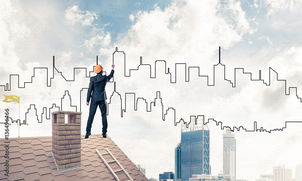 Man architect draw silhouette of modern city on blue sky. Mixed Man architect draw silhouette of modern city on blue sky. Mixed