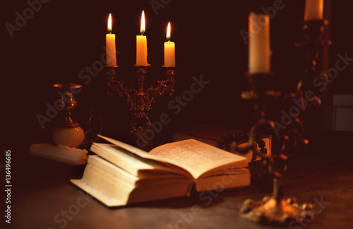 Wallpaper Mural Burning candles with Bible on dark background Torontodigital.ca