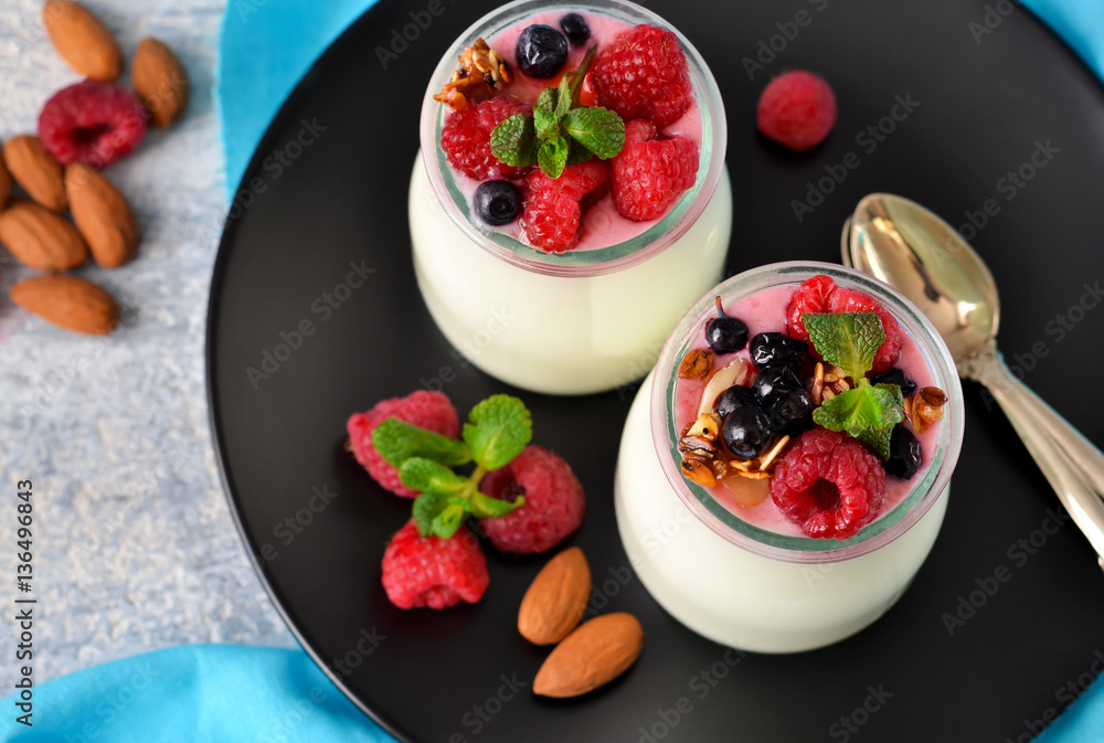 Vanilla yogurt with berries on a concrete background. Vanilla yogurt with berries on a concrete background.