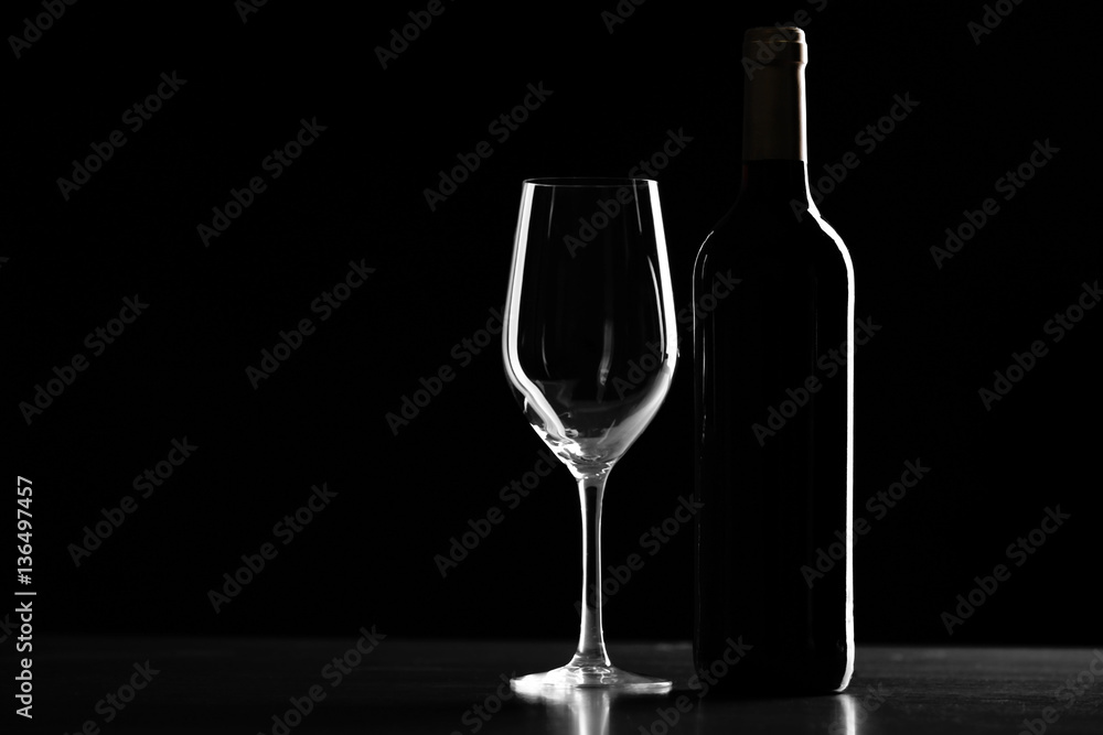 Bottle of wine and glass on black background Bottle of wine and glass on black background