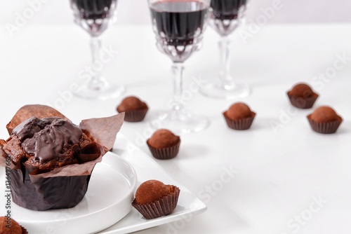 Delicious chocolate cake  truffles and red wine on white background