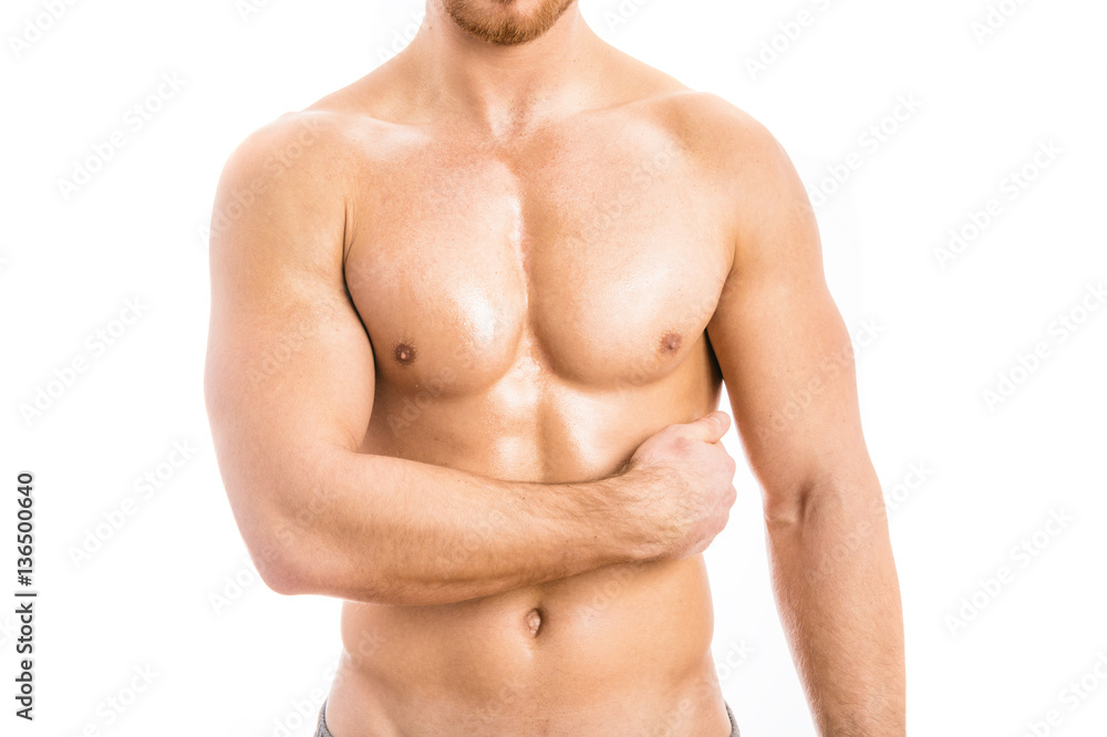 Muscular young man isolated on white background.