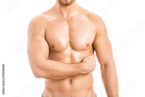 Muscular young man isolated on white background.