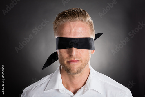 Businessman With A Black Blindfold Over Eyes photo