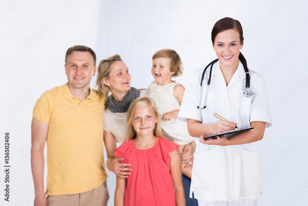 Doctor Writing Prescription With Family Doctor Writing Prescription With Family