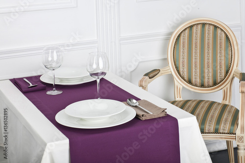 Beautifully decorated table with linen napkins, plates and glasses luxurious tablecloths 