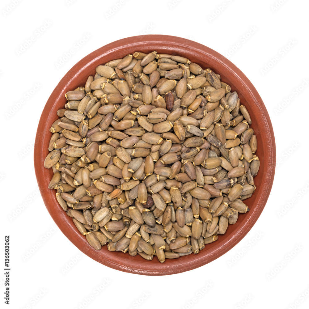 Organic milk thistle seeds in a small bowl top view isolated on a white background.
