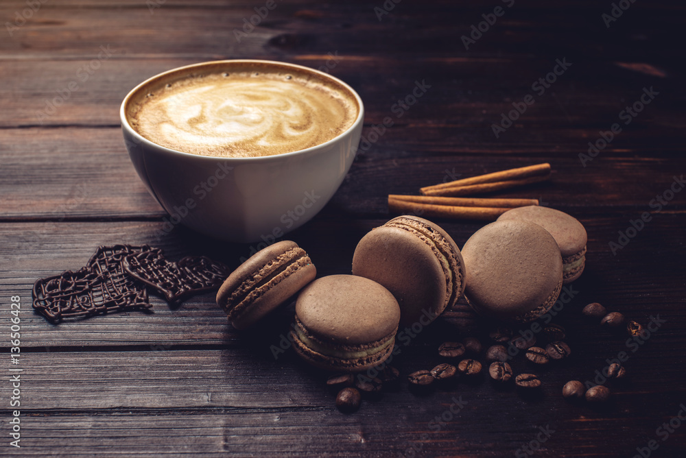 Coffee with macarons and chocolate in the shape of heart. Coffee with macarons and chocolate in the shape of heart.