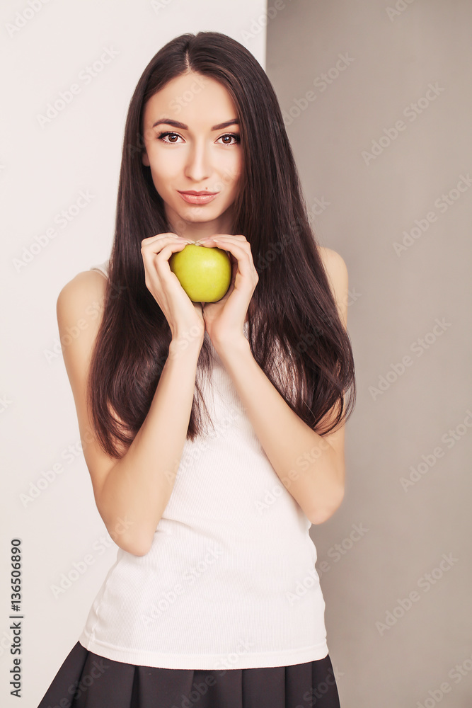 Diet. A young woman watches her figure and eating fresh fruit. The concept of healthy eating. Diet. A young woman watches her figure and eating fresh fruit. The concept of healthy eating.