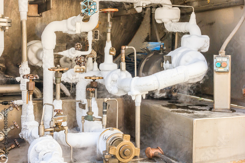 Close up of container with liquid nitrogen,Cold metal pipe smoking from transferring liquid nitrogen photo