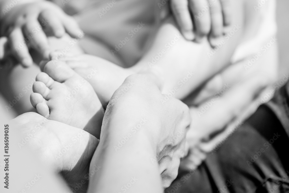 tiny baby feet in mother's hands tiny baby feet in mother's hands