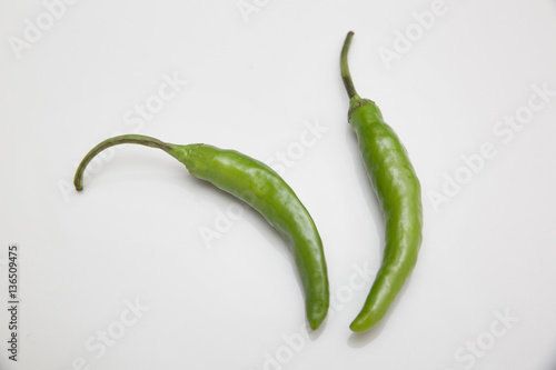 Green chili peppers on white background