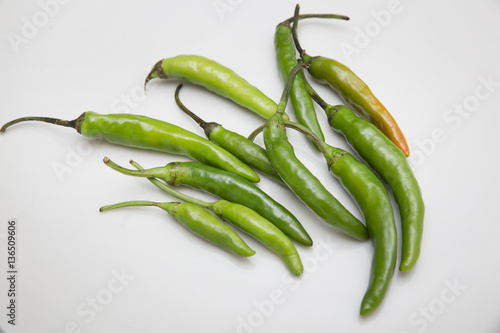 Green chili peppers on white background