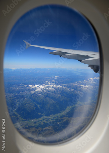 Looking through window, airplane wing and terrain with a nice bl