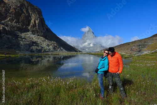 asian couple traveler smiling in front of Riffelsee lake and Ma