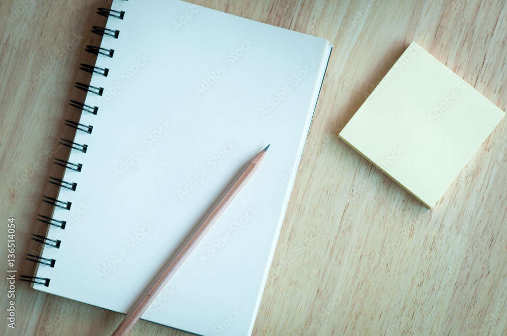 Notebook and pencil on wooden table. Notebook and pencil on wooden table.