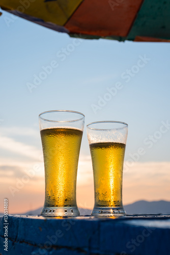 Glass of beer on a sunset