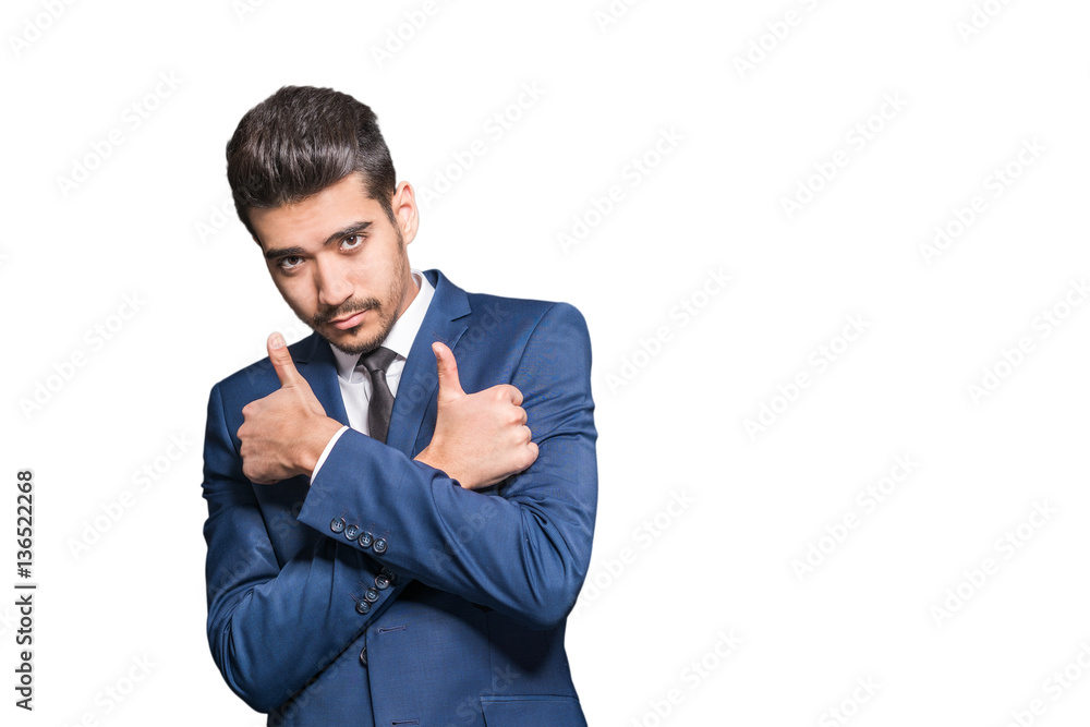 Young attractive man in a blue suit showing thumb up on a white background. Isolated Young attractive man in a blue suit showing thumb up on a white background. Isolated