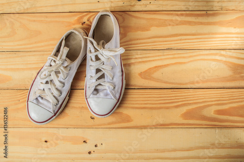 White sneakers on hardwood floors.
