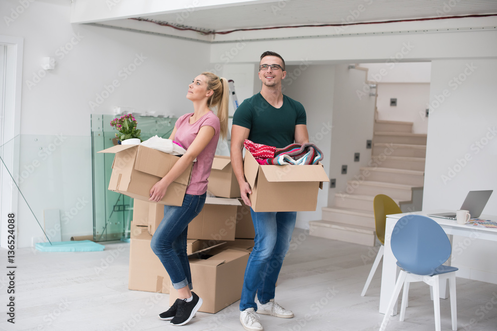 young couple moving into a new home young couple moving into a new home