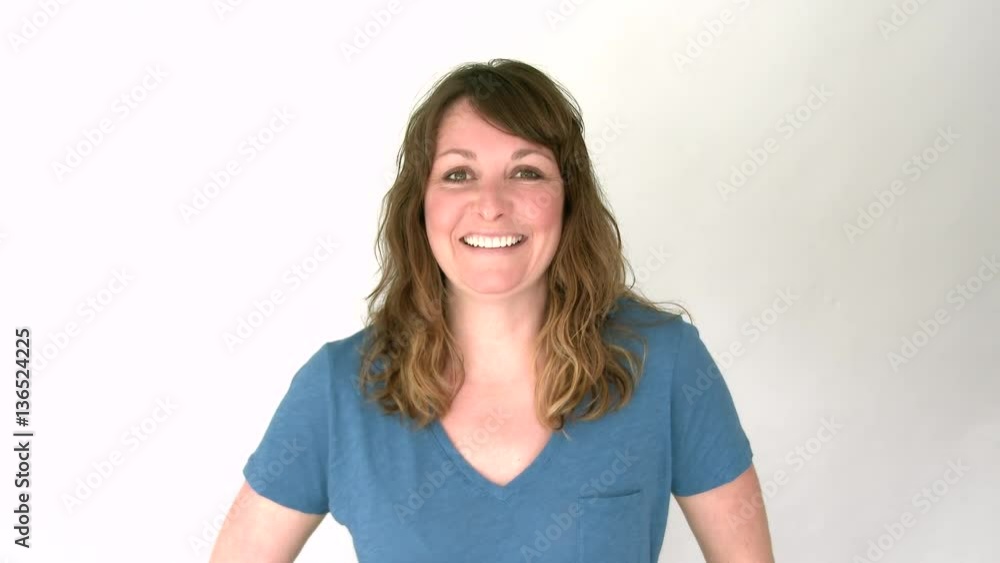 Model released woman in studio looking at camera smiling and laughing. Model released woman in studio looking at camera smiling and laughing.