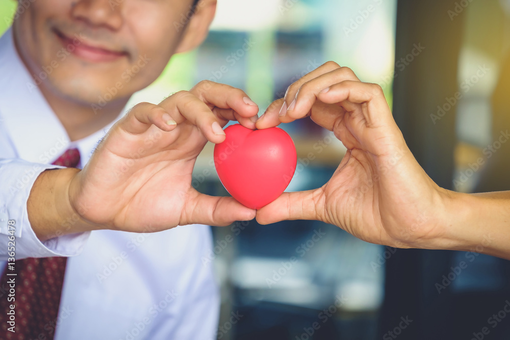 Concept love for two people holding red heart together. Concept love for two people holding red heart together.