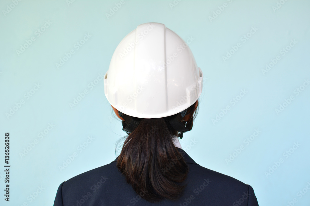 Portrait of engineer holding hat on blue background, selective and soft focus Portrait of engineer holding hat on blue background, selective and soft focus