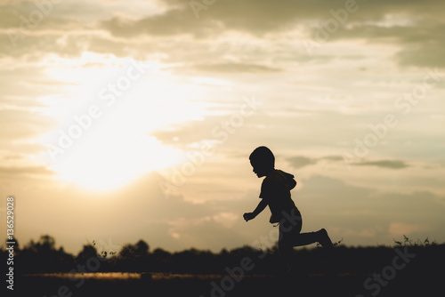 silhouette A boy run at sunset