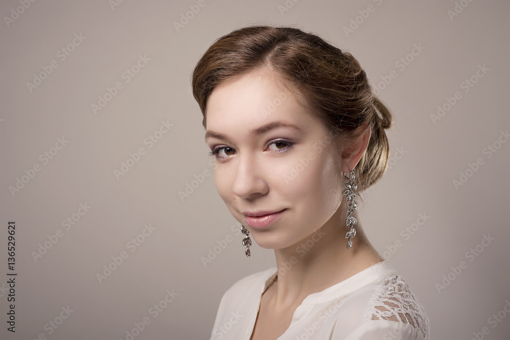close-up portrait of girl with wedding hairstyle on gray isolated background close-up portrait of girl with wedding hairstyle on gray isolated background