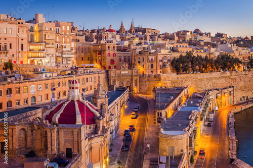Valletta, Malta - The traditional houses and walls of Valletta, the capital city of Malta on an early summer morning before sunrise with clear blue sky