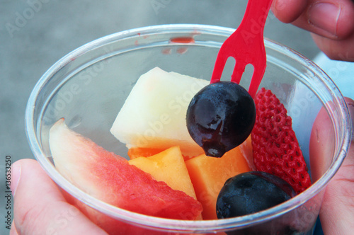 Plastic cup of fresh cut fruit