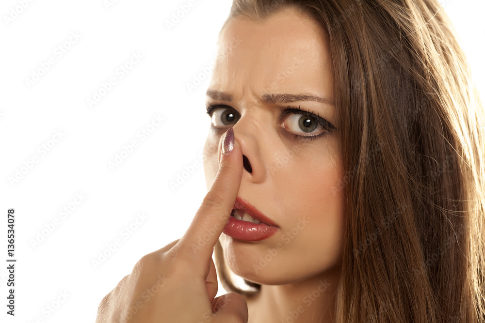 young unhappy woman raised her nose on white background young unhappy woman raised her nose on white background