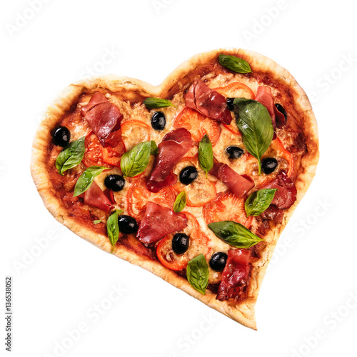 Pizza heart love Valentine's Day romantic Italian restaurant dinner food. Prosciutto, olives, tomatoes, parsley, basil and mozzarella cheese meal on black