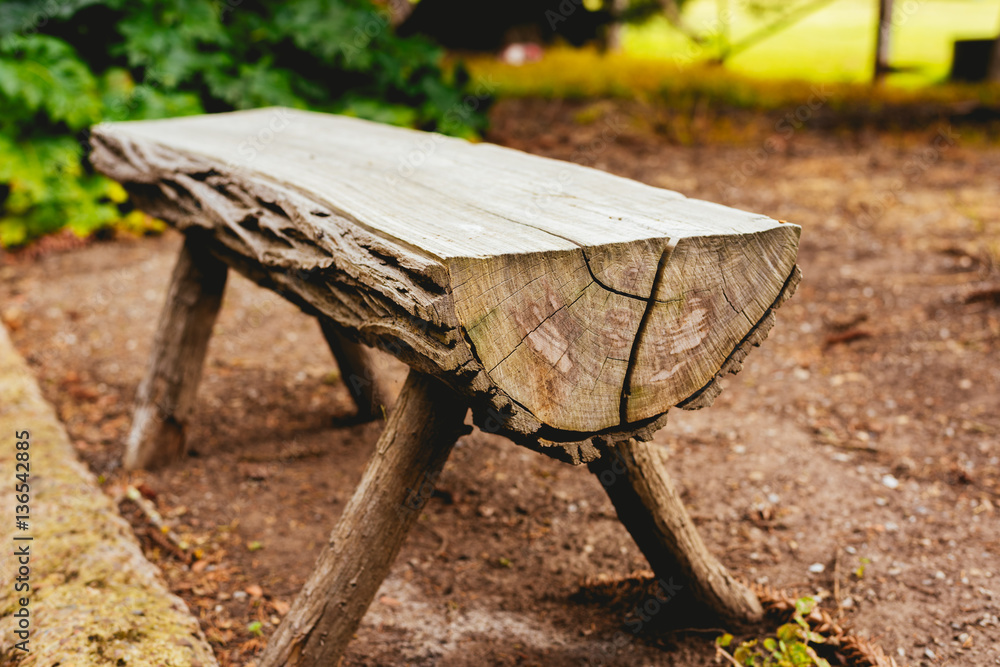 Close-up of a bench made of trunks in the garden Close-up of a bench made of trunks in the garden