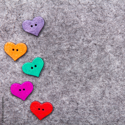 Wooden hearts on gray felt background  copy space