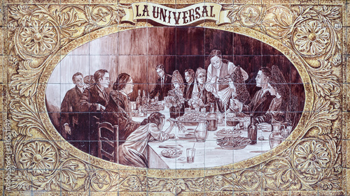 Tiled mural from Triana area, Seville, Andalucia, Spain. Mural depicting patrons enjoying meal