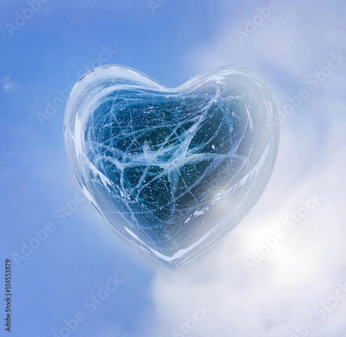 Blue Ice heart with bubbles and cracks isolate