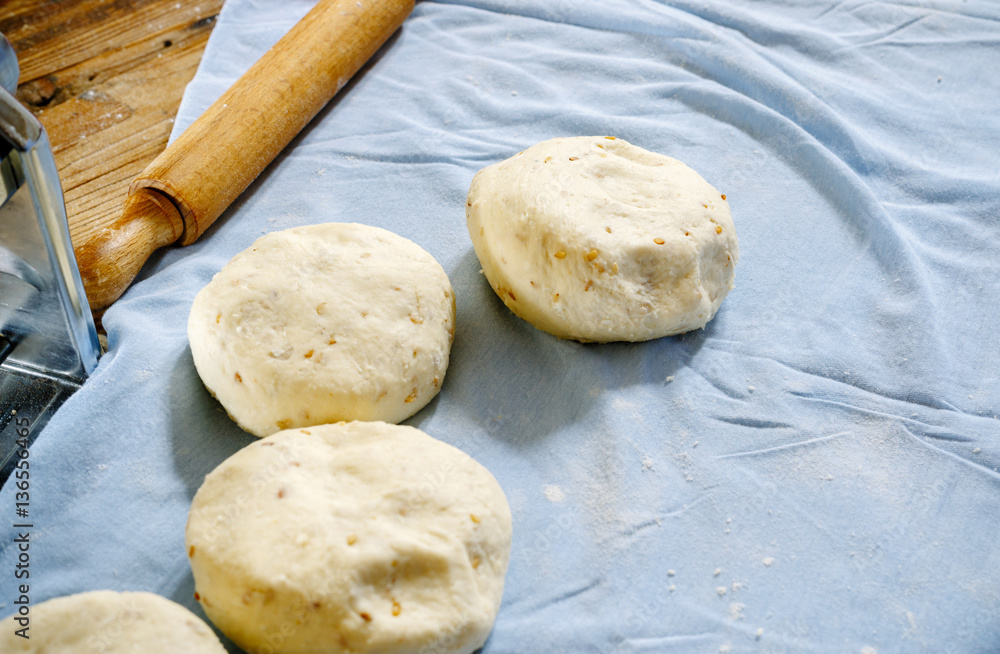 Pita dough with rolling pin. Pita dough with rolling pin.