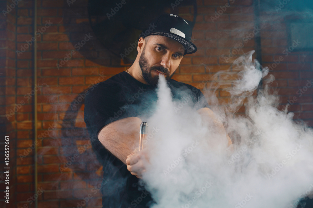 Man vaping an electronic cigarette Man vaping an electronic cigarette