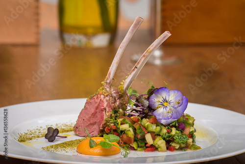 Lamb ribs with vegetables salad and edible flowers